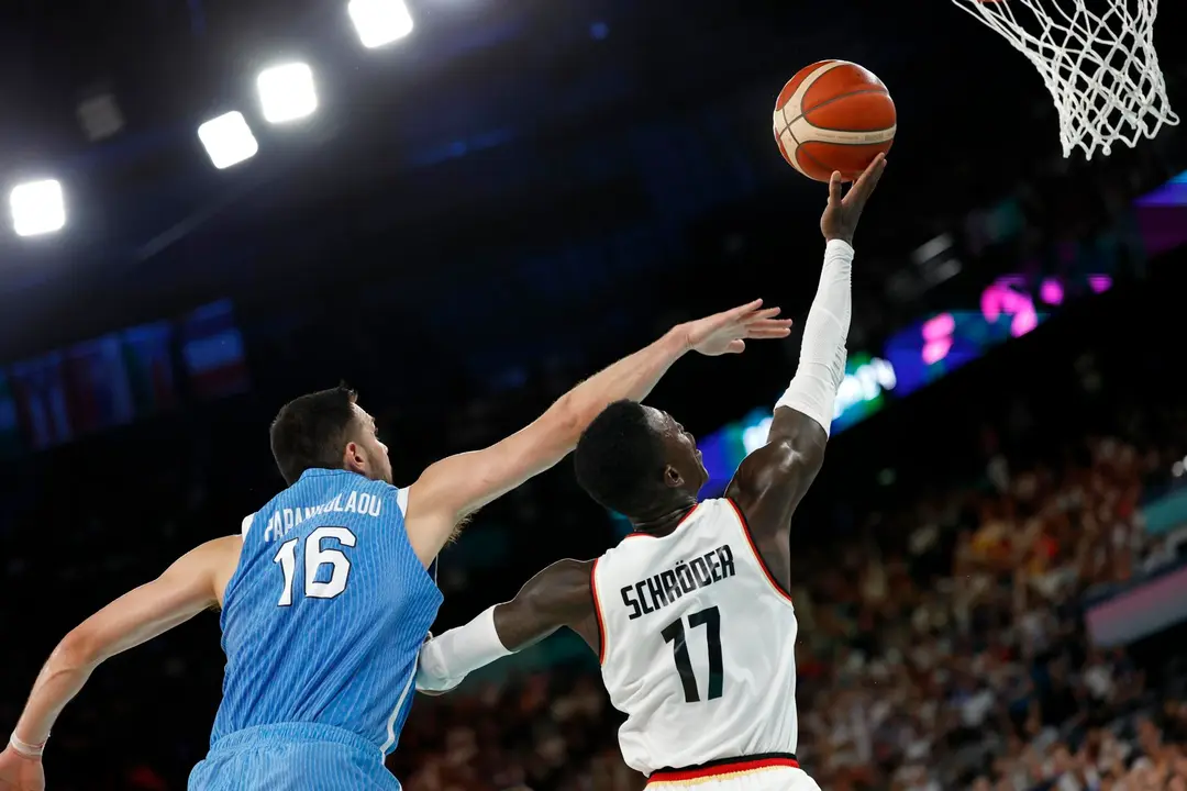 Dennis Schroder, de Alemania (d), entra a canasta ante Kostas Papanikolaou, de Grecia (i), durante el partido de cuartos de final d los Juegos Ol&iacute;mpicos 2024 que los enfrent&oacute; en el Bercy Arena de Par&iacute;s. EFE/EPA/CAROLINE BREHMAN