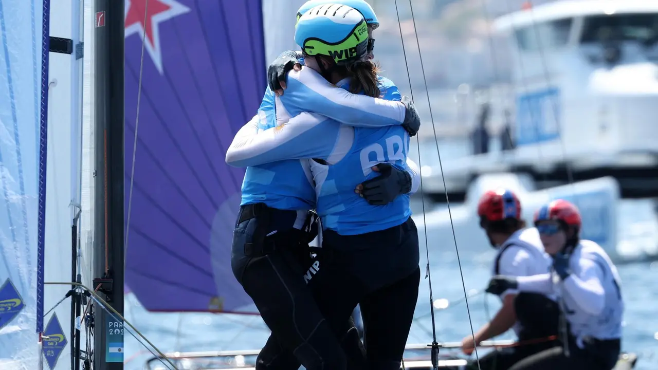 Los argentinos Mateo Majdalani y Eugenia Bosco celebran la medalla de plata en Nacra. EFE/EPA/OLIVIER HOSLET